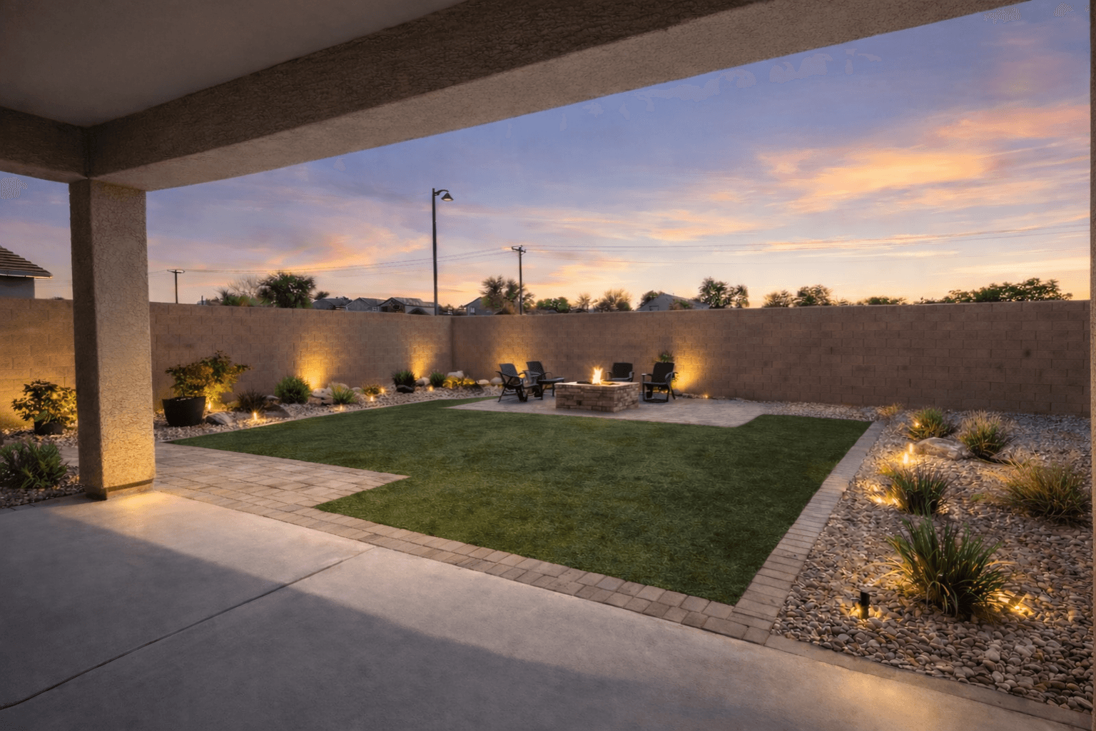 After — remodeled backyard with turf, pavers, fire pit, and lighting — Phoenix, AZ