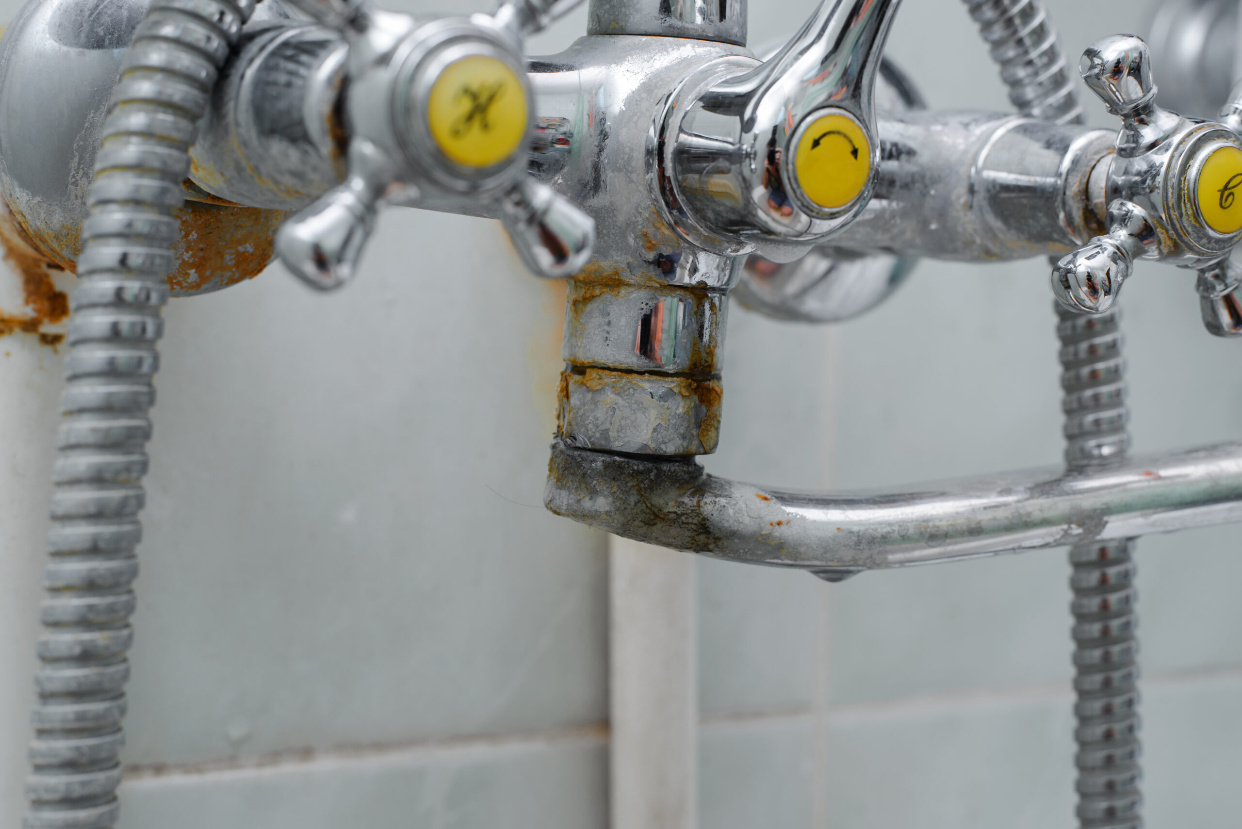 Close-up of rusty faucet highlighting minor repairs sellers should fix