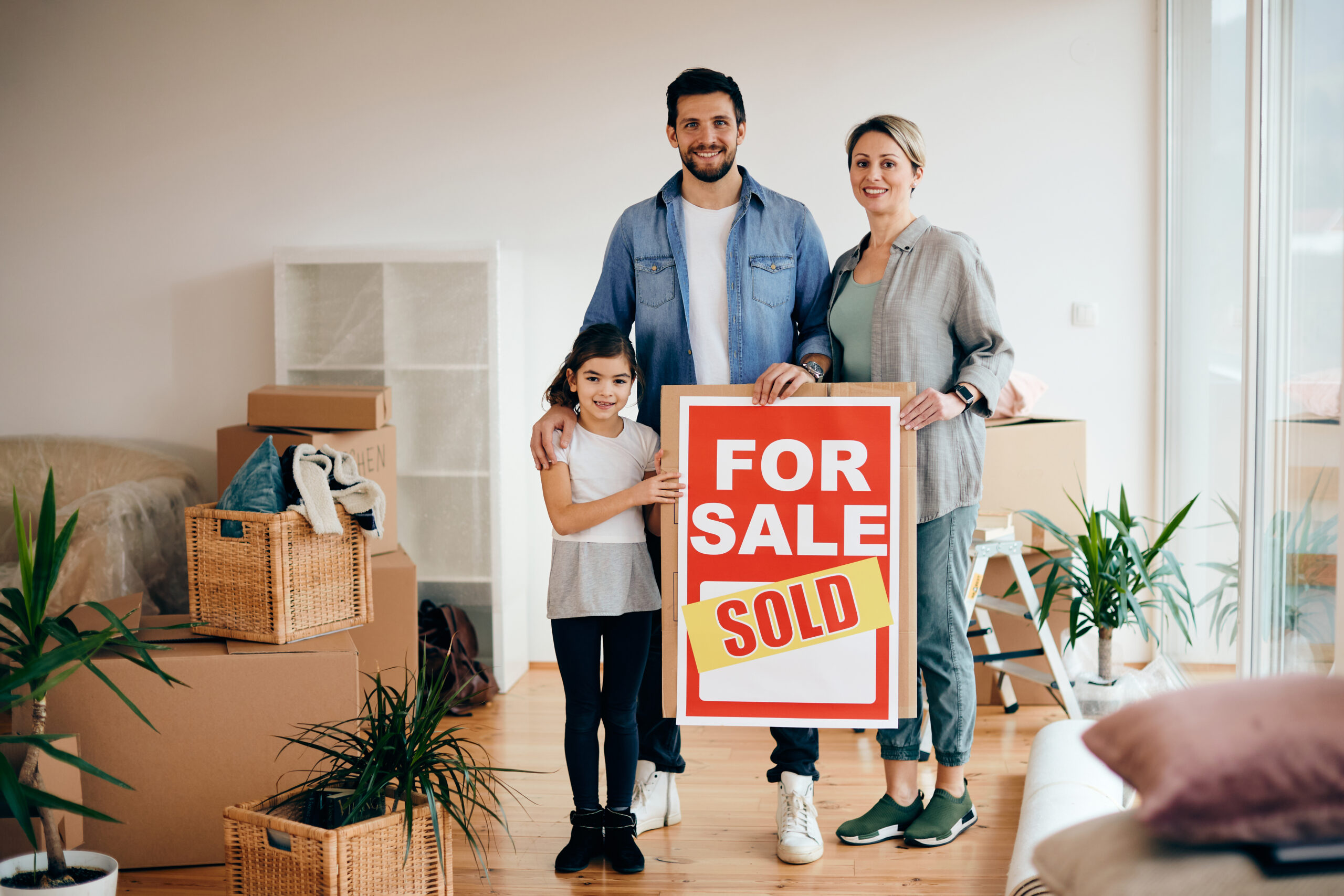 Happy Arizona family with sold sign after successful home sale